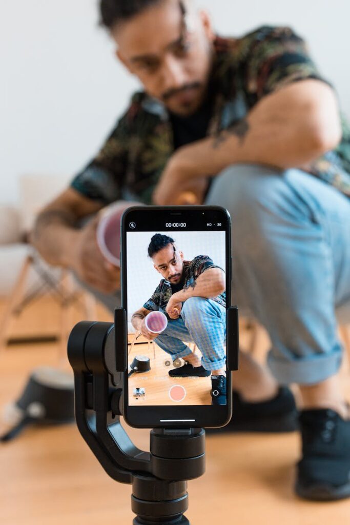 A Man Filming Himself Using His Mobile Phone